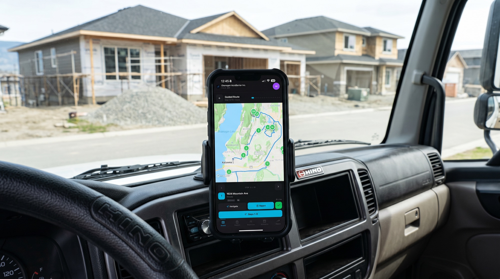 LeadX running on a phone mounted in a work truck cab at a job site, showing the territory route map